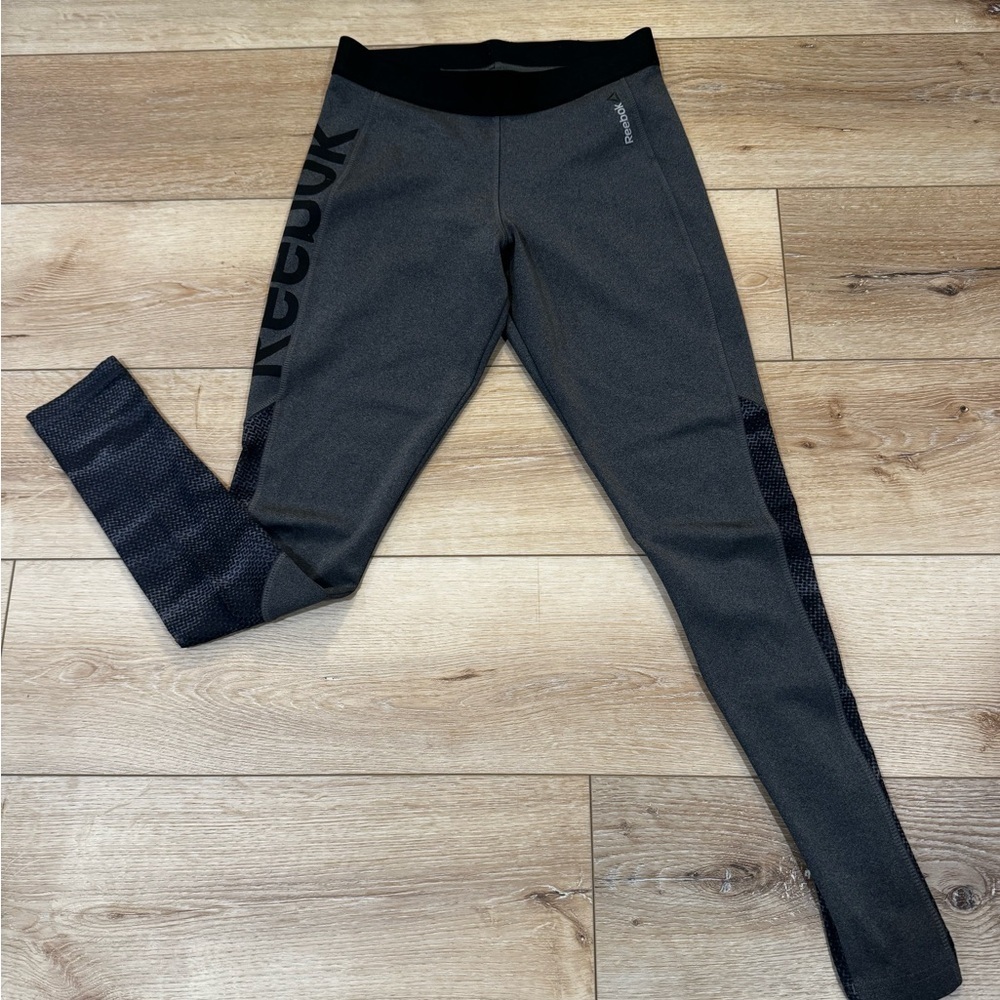 Reebok charcoal gray athletic leggings, mesh patterned detailing on side, S.